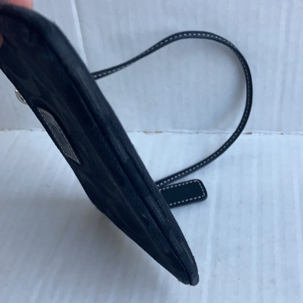 Coach black signature C mini wristlet.